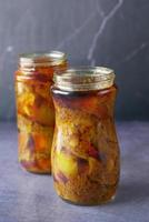Homemade Mango Pickle in a glass jar on table , photo