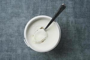 fresh yogurt in a bowl on table photo