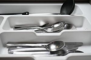 cutlery fork, knife and spoon in a drawer photo