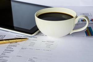 Business report with cup of coffee photo