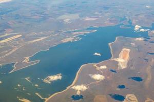 Aerial photo of Farmland. view from the plane to the ground. squares of fields under the clouds