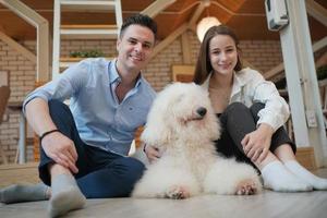 Man and girl with his pet dog playing on the floor. Happy dog, happy guy with dog. photo