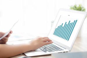 Beautiful young asian woman working laptop computer, businesswoman looking graph diagram analysis statistic data with excited and success, girl using notebook, business concept. photo