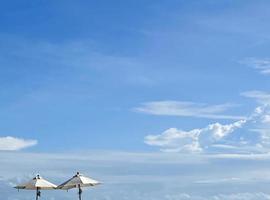 White beach umbrella on beach summer day photo