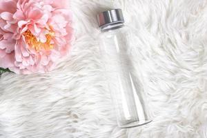 Styled mockup of clear plain glass water bottle. photo