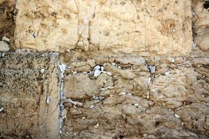 Notes in the Wailing Wall in Jerusalem with their requests and desires addressed to God. photo