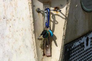 An iron padlock hangs on a closed gate photo