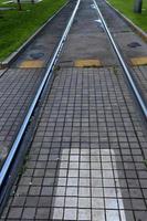 A road with rail tracks intended for the movement of railway rolling stock. photo