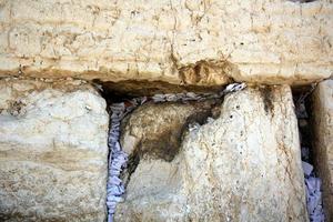 Notes in the Wailing Wall in Jerusalem with their requests and desires addressed to God. photo