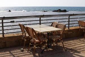 Chair and table in a cafe on the Mediterranean coast photo