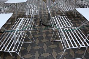 Table and chairs in a cafe in a city park photo