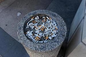 Ashtray - a container for tobacco ash, cigarette butts, cigars. photo