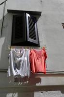 Laundry drying on the street in a big city photo