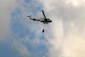 A UN helicopter puts out a fire in a forest on the Israel-Lebanon border. photo