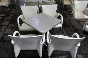 Table and chairs in a cafe in a city park photo