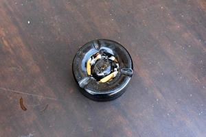 Ashtray - a container for tobacco ash, cigarette butts, cigars. photo