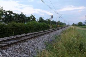 A road with rail tracks intended for the movement of railway rolling stock. photo