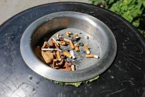 Ashtray - a container for tobacco ash, cigarette butts, cigars. photo