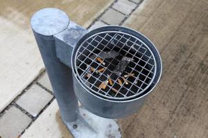 Ashtray - a container for tobacco ash, cigarette butts, cigars. photo