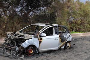 Burnt out car on the road photo