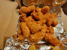 pile of boneless chicken wings with spicy sauce photo