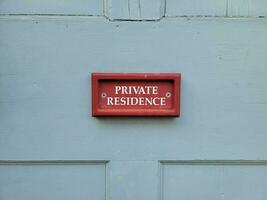 red private residence sign on blue wood door on home photo