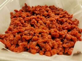 pile of ground raw red beef meat in foam container photo