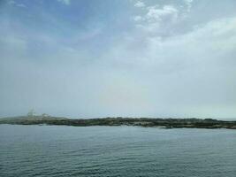 lighthouse and rocky shore on the coast of Maine photo