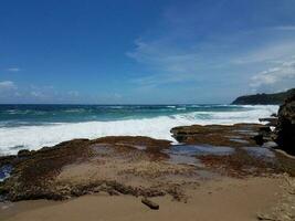 ocean water at Guajataca beach in Isabela Puerto Rico with rocks photo