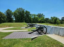 metal cannons artillery with wheels and fort wall photo