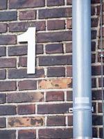 brick wall with house number 1 photo