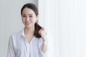 Asian beautiful woman in white shirt is smiling photo