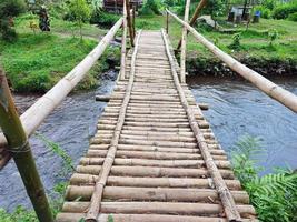 unique bamboo bridge over the river photo