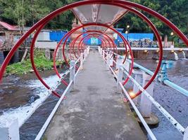 The red bridge spans the river photo