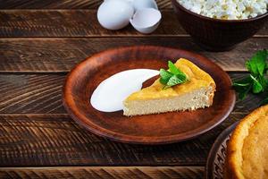 Homemade cottage cheese casserole on rustic wooden background