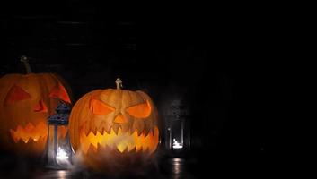 Halloween background with pumpkin head lantern and candles. Halloween pumpkin Jack-o-Lantern photo