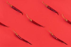 Dried red chili pepper on red background. Texture of isolated chili peppers photo