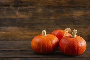 Mini pumpkins on wooden background. Thanksgiving day concept. photo