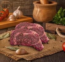 raw meat gf rib eye barbecue isolated on kitchen background photo