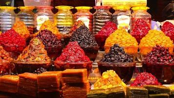 Piles of various colorful tasty candy sweets on bazaar for sale in iranian street market video