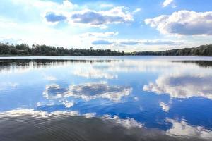 North Germany Stoteler See Lake blue water with cloud reflection. photo