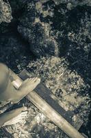 Feet at blue turquoise water limestone cave sinkhole cenote Mexico. photo