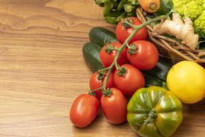 Livorno Tuscany Italy December 2020 A brown wooden table with a basket of fresh seasonal vegetables on it photo