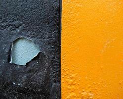 The surface of the wall painted with brown is peeling off. You can see the concrete floor inside. Use it as a background and wallpaper. Copy space photo