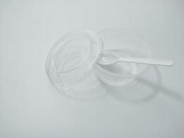 Transparent plastic cups placed on a white background Used in food packages Which is a disposable plastic product Which causes environmental pollution Affecting global warming photo