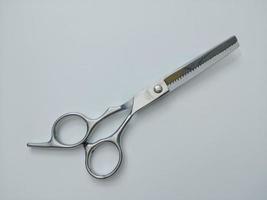 Stainless steel scissors on a white background give the hairdresser hair clipper concept. photo