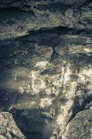 Blue turquoise water limestone cave sinkhole cenote Tajma ha Mexico. photo