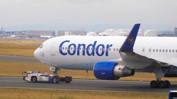 FRANKFURT AM MAIN, GERMANY JULY 21, 2017 - Condor Thomas Cook Boeing 767 D ABUC towing by tractor to service. Fraport, Frankfurt, Germany video