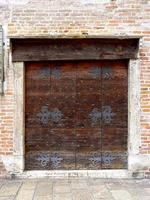 close up wooden door with brick wall photo