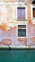 ancient brick wall of building and canal photo